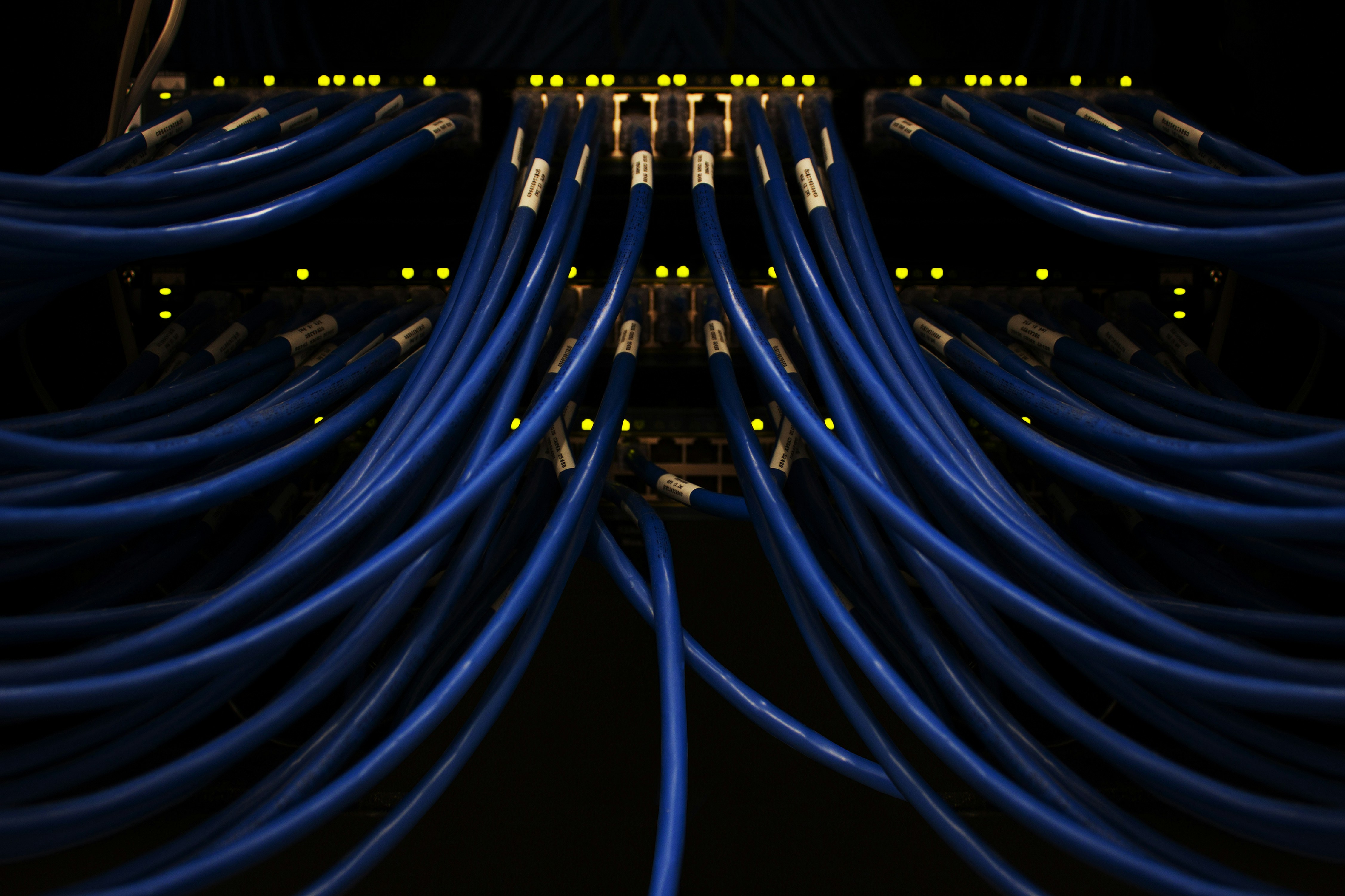Person working on IT infrastructure and network systems across multiple monitors