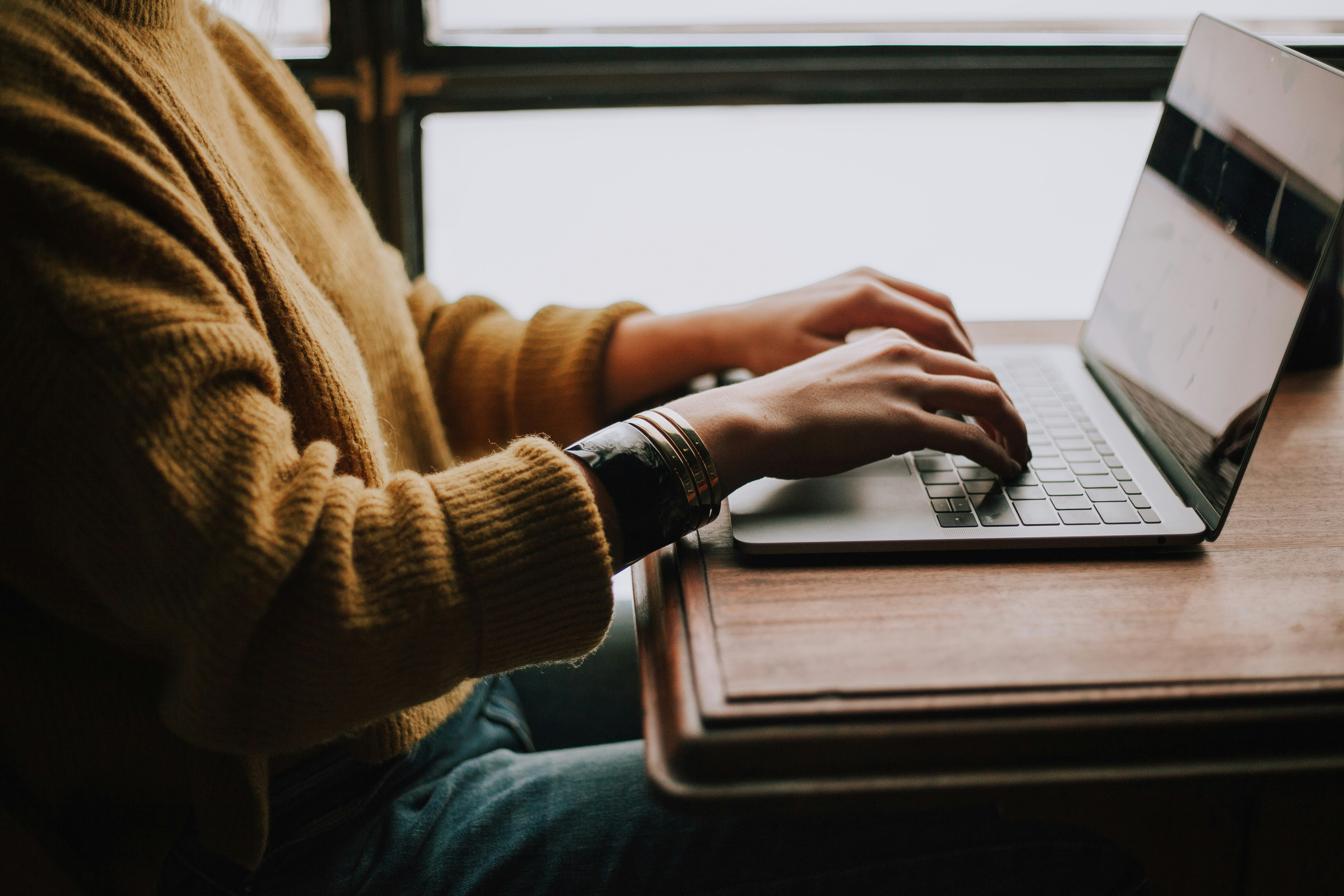 Student studying confidently on a laptop at home, representing the flexibility of an online degree