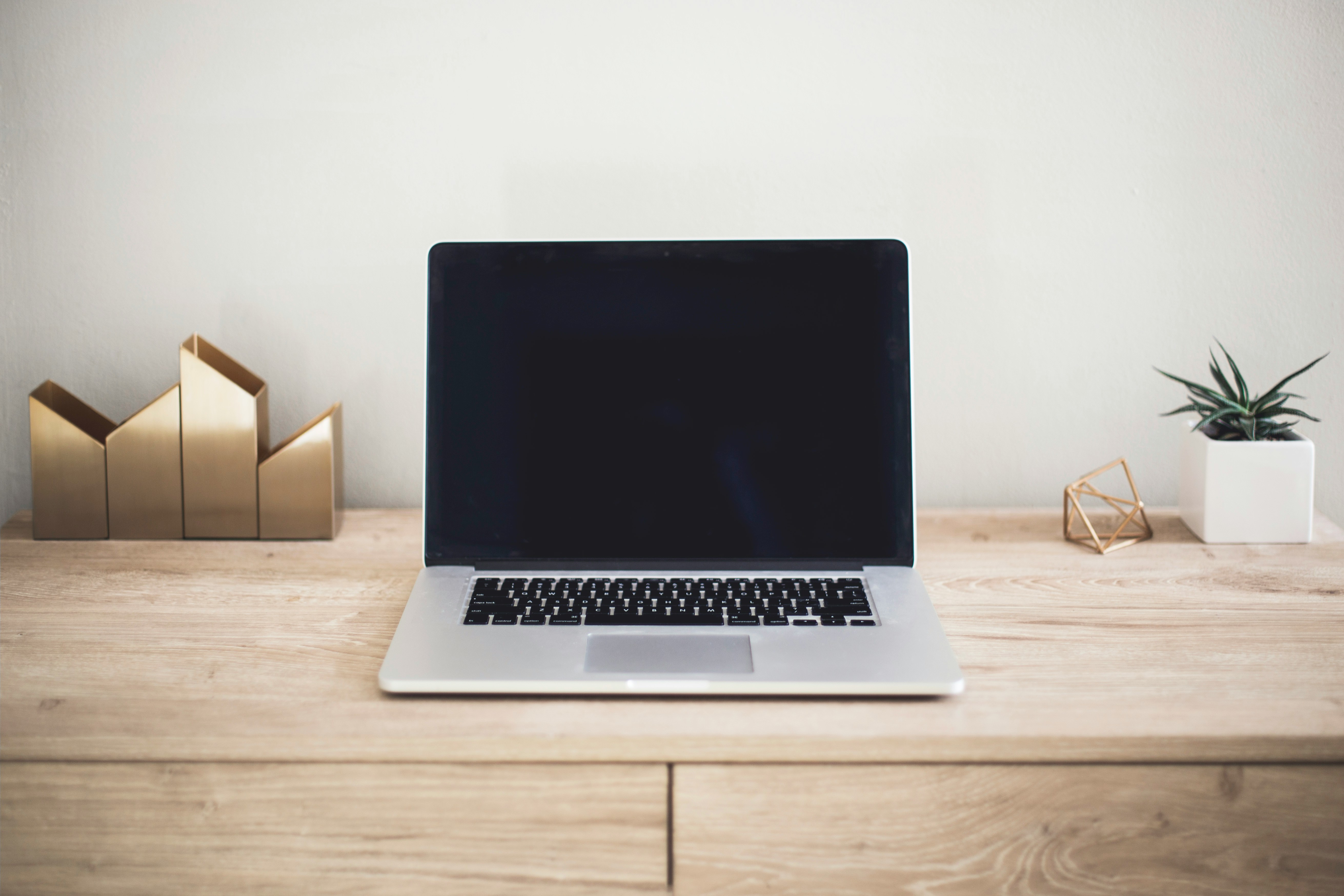 Person completing an online degree application on a laptop at a desk