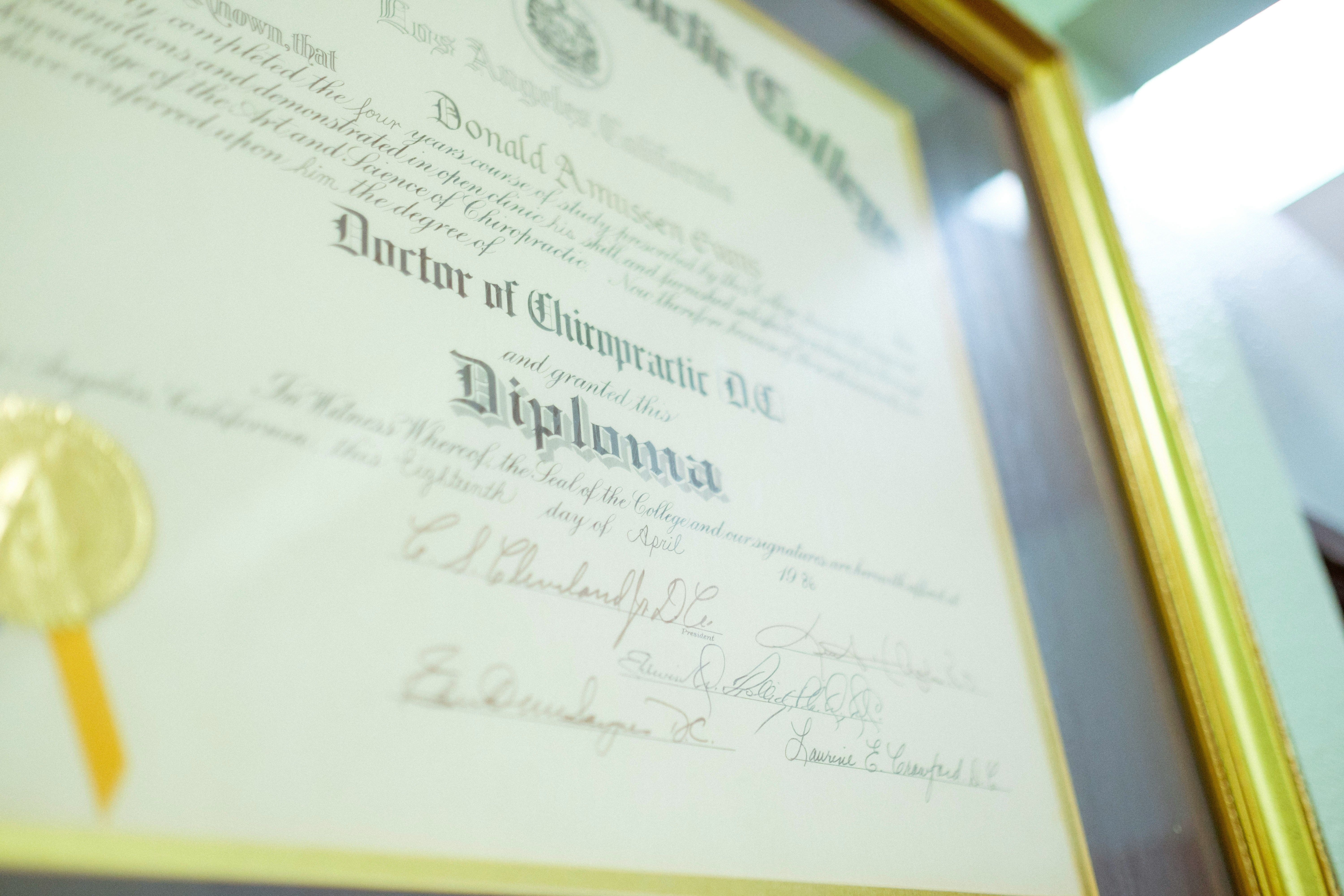 Two study paths represented by a diploma certificate and a graduation cap on a desk