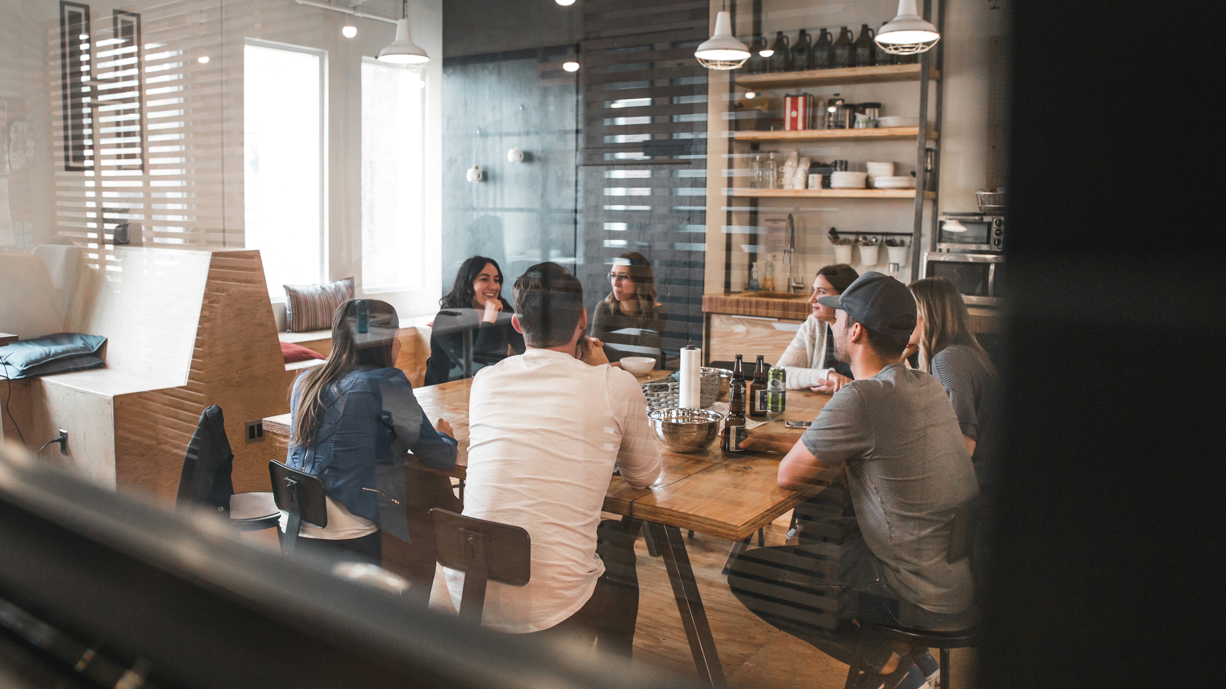 Professionals collaborating around a laptop in a modern office, representing in-demand workplace skills