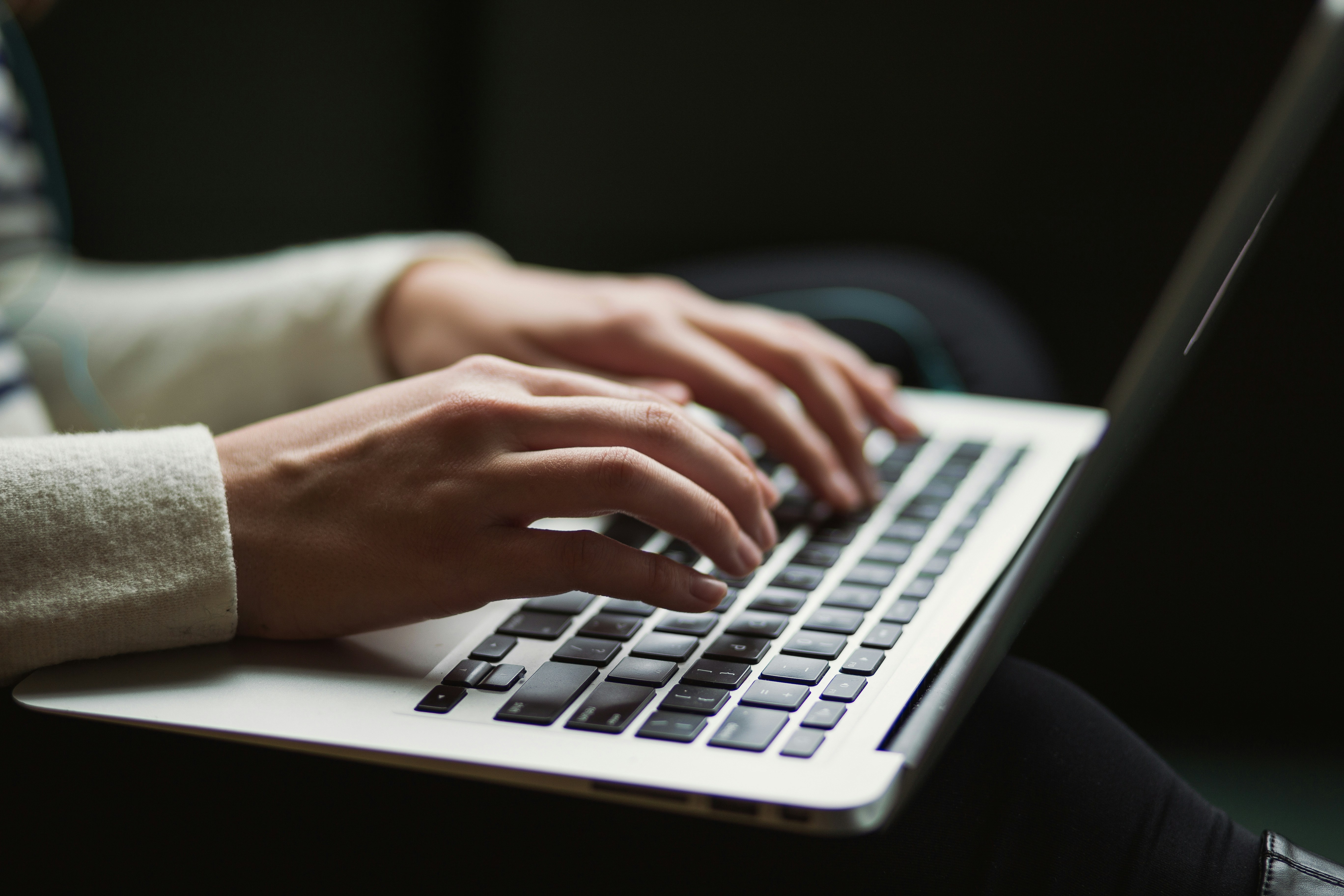 Student researching online degree programmes on a laptop at home